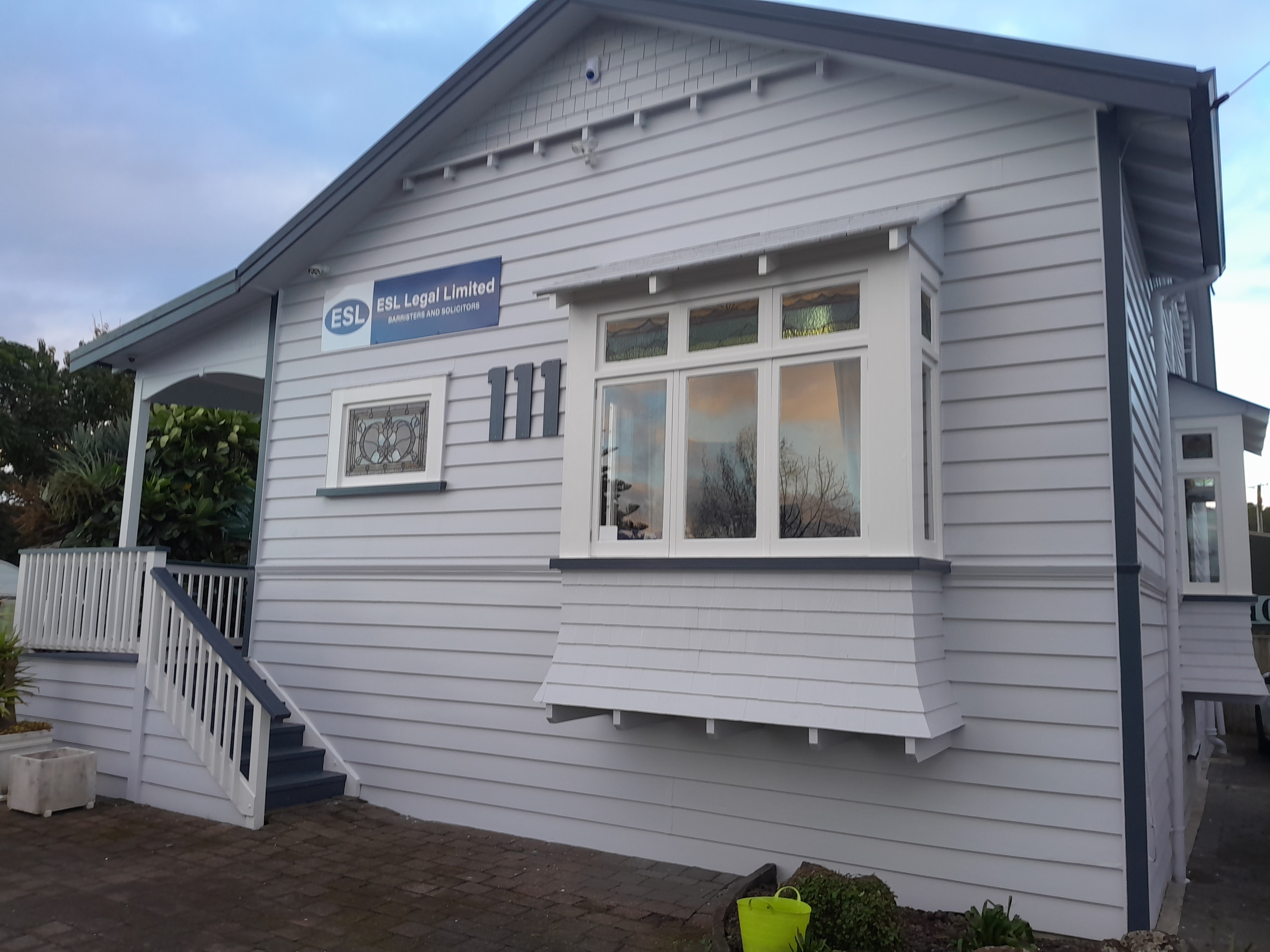 Freshly painted villa-style commercial building in blue-grey weatherboard